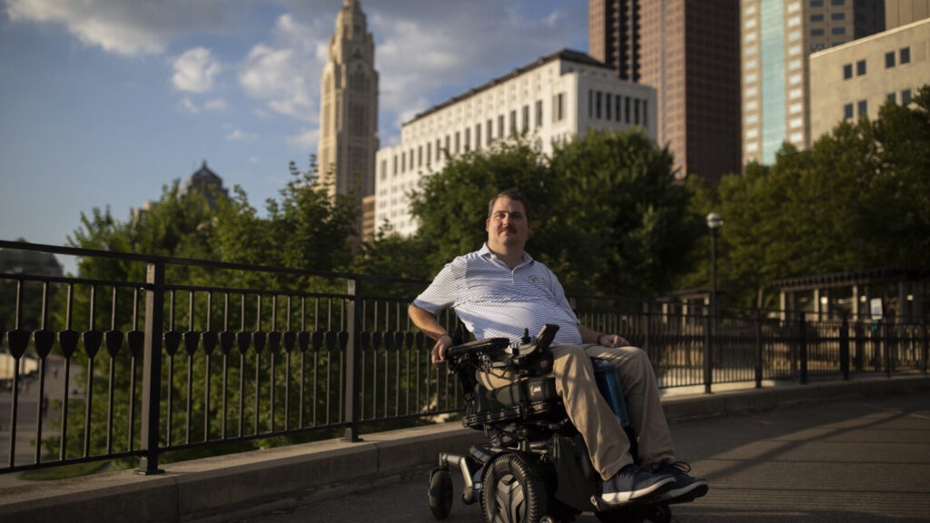 Ian Burkhart poses for a portrait along the Scioto Mile in Columbus, OH on July 10, 2022. Burkhart is a former brain-computer interface participant at The Ohio State University who formed a foundation to help spinal cord injury patients